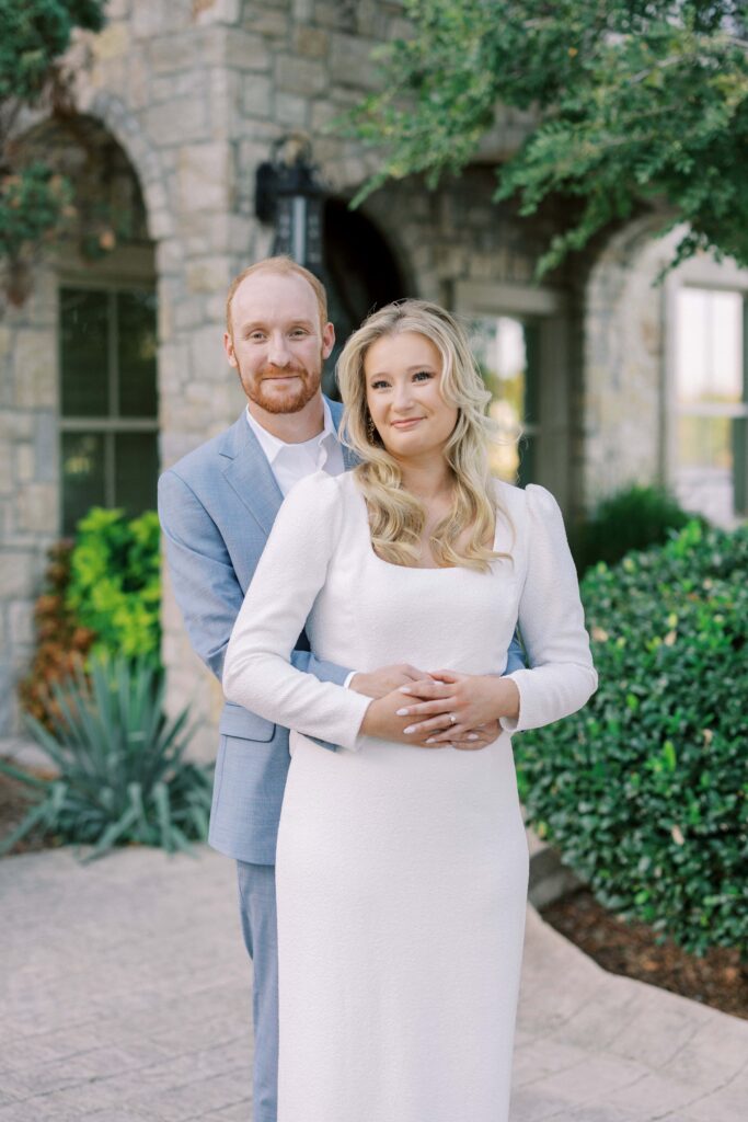 groom holding bride by the waist during their Adriatica Village Engagement session