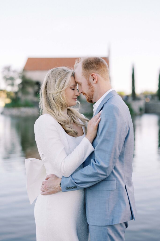 bride and groom forehead to forehead during their Adriatica Village Engagement session