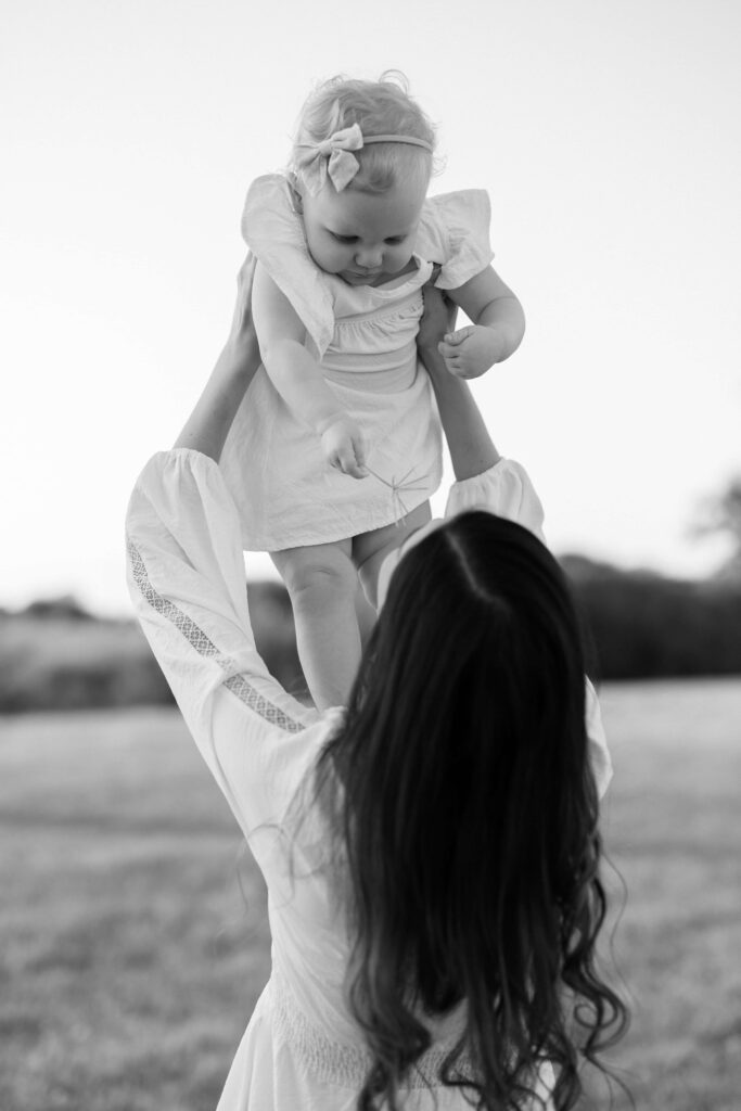 Jessica holding her baby up at her Sansom Park family session