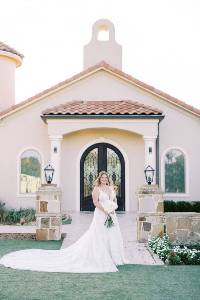 Nicole standing in front of the chaoel for her D'Vine Grace Vineyard bridal session