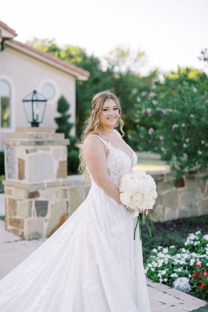 Nicole in the courtyard holding her bouquet for her D'Vine Grace Vineyard bridal session