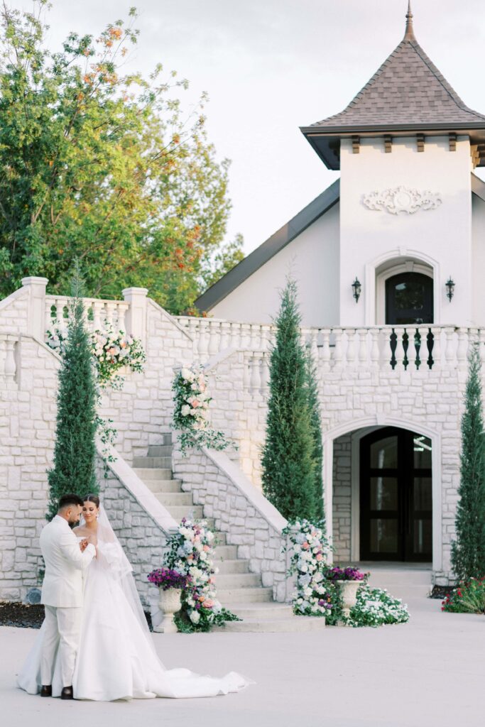 bride and groom holding hands in front of their venue at their brighton abbey wedding