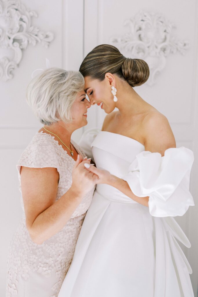 bride forehead to forehead with her mom at this brighton abbey wedding 