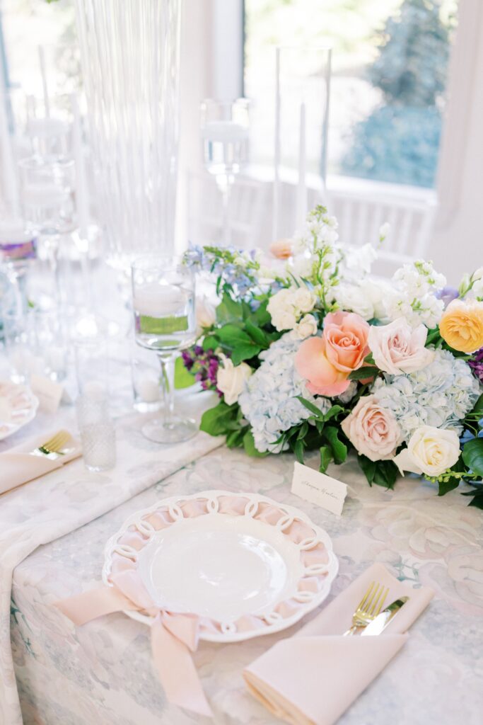 tablescape with purple, peach, pink, blue florals at this brighton abbey wedding 