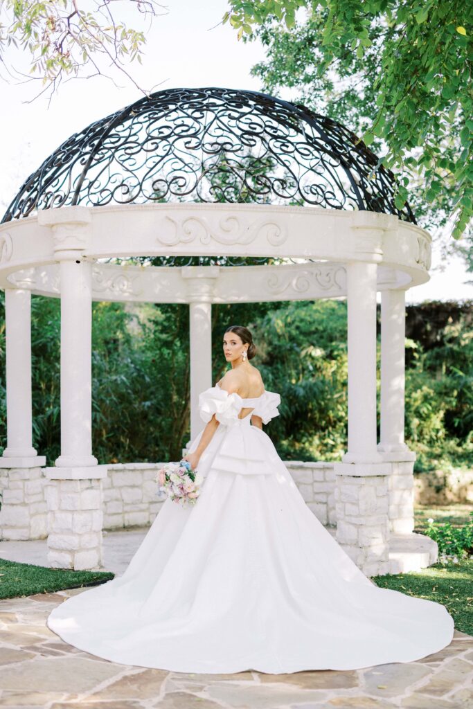 bride standing by the gazeboin the yard at her brighton abbey wedding