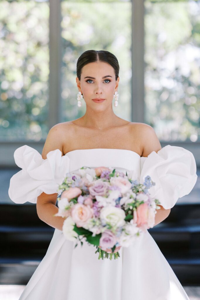 bride showing off her bouquet at her brighton abbey wedding 