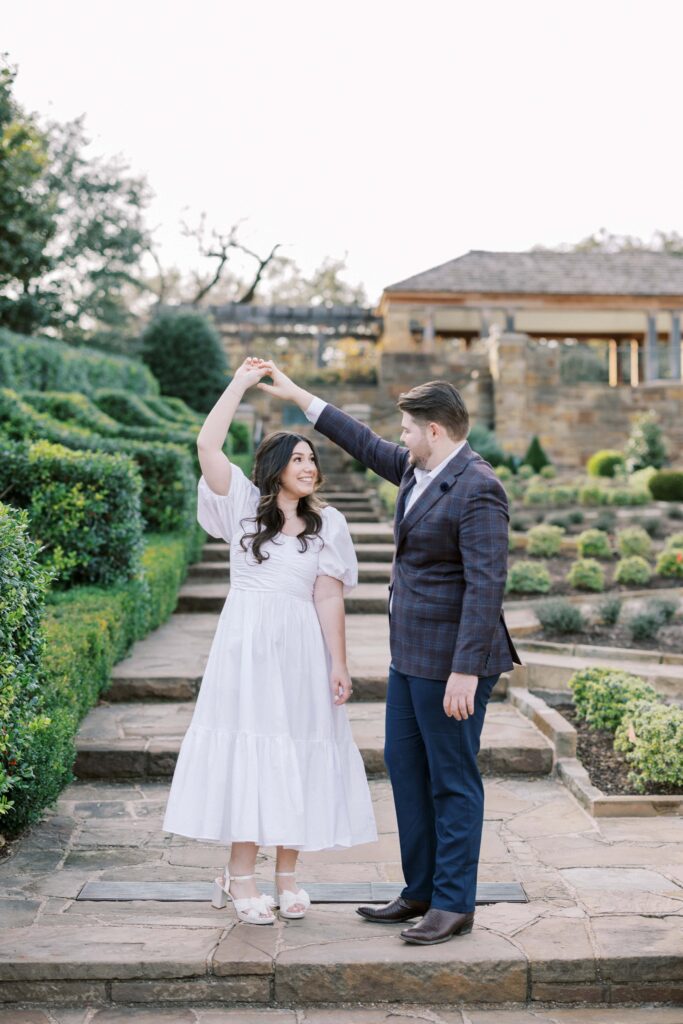 Caleb and Tori twirling at their Fort Worth Botanic Garden Engagement