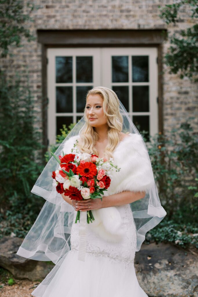 bride holding her red bouquet at The Springs Event Venue Waxahachie