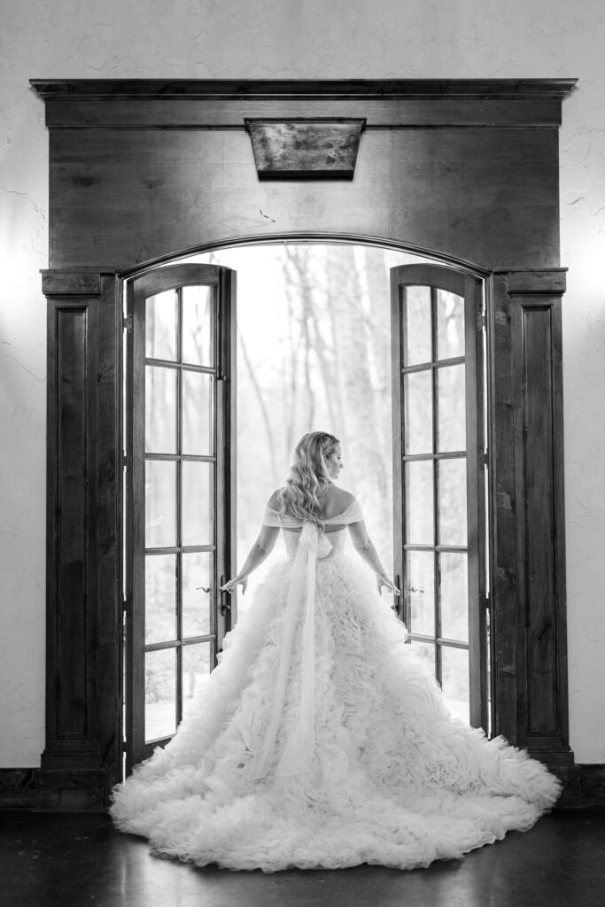 bride holding the doors at The Springs Event Venue Waxahachie