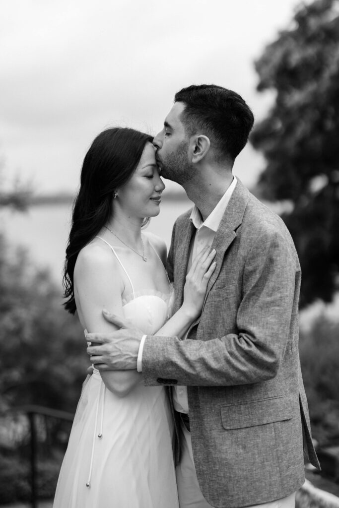 Alessandro kissing Rita's forehead during their engagement photos at the Dallas Arboretum