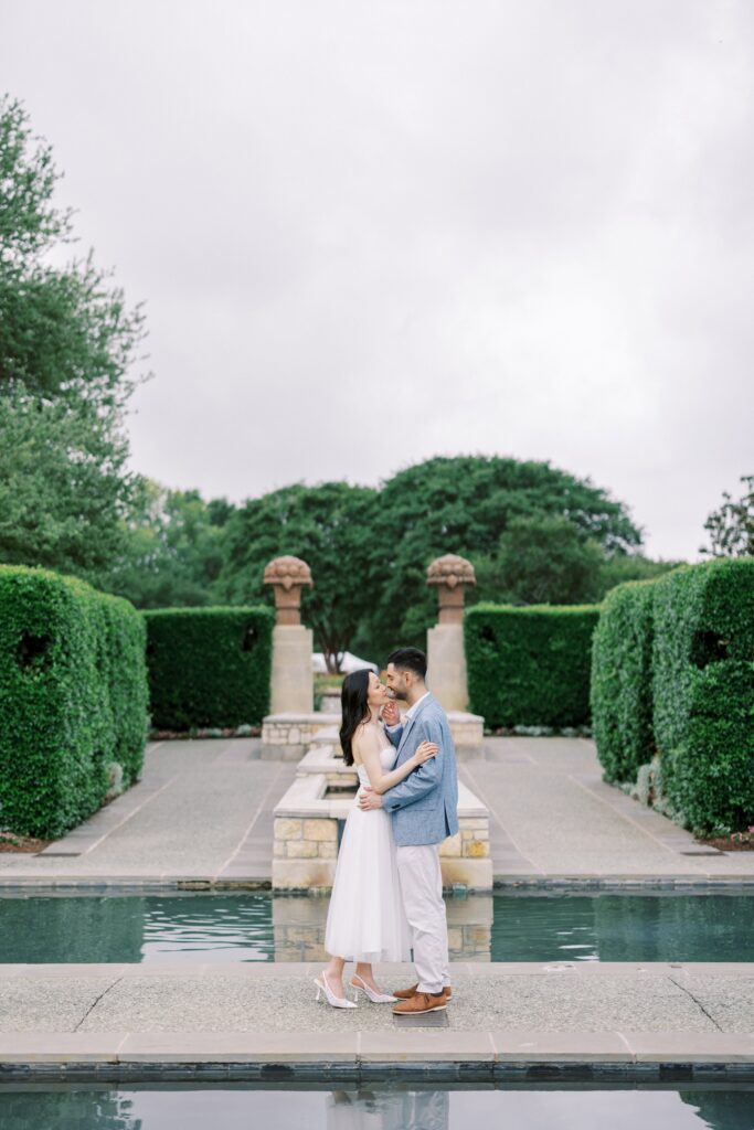 couple looking at each other during their engagement photos at the Dallas Arboretum