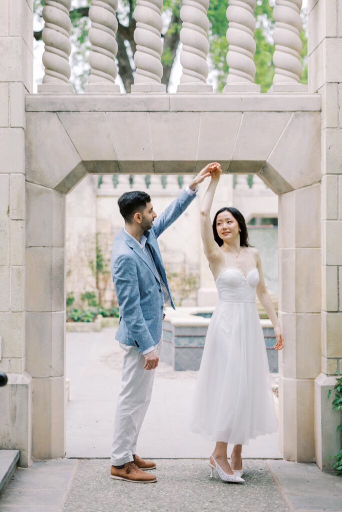 Rita twirling at her engagement photos at the Dallas Arboretum