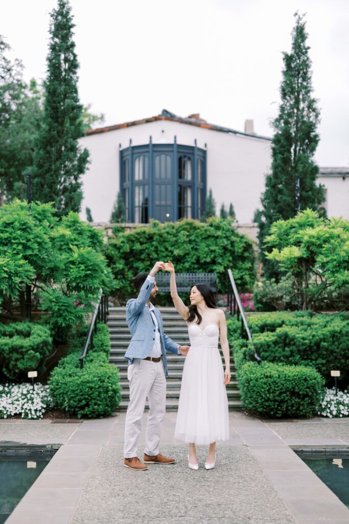 couple dancing during their engagement photos at the Dallas Arboretum
