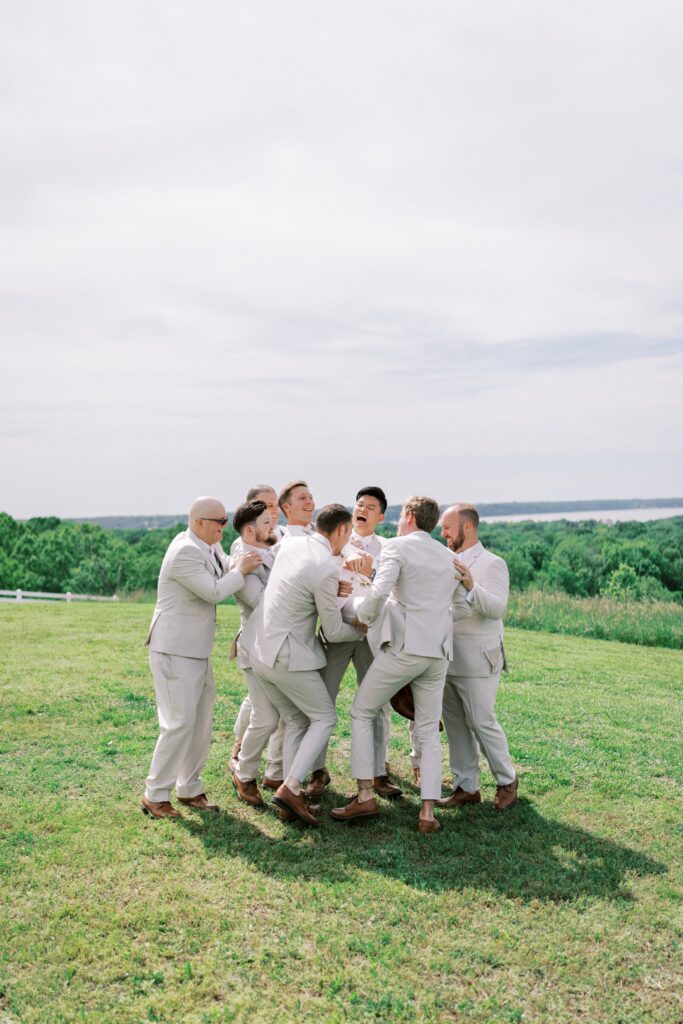 groomsmen carrying the groom at this Lakeview Hills Wedding