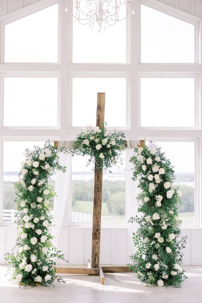 cross adorned with all white flowersat this Lakeview Hills Wedding