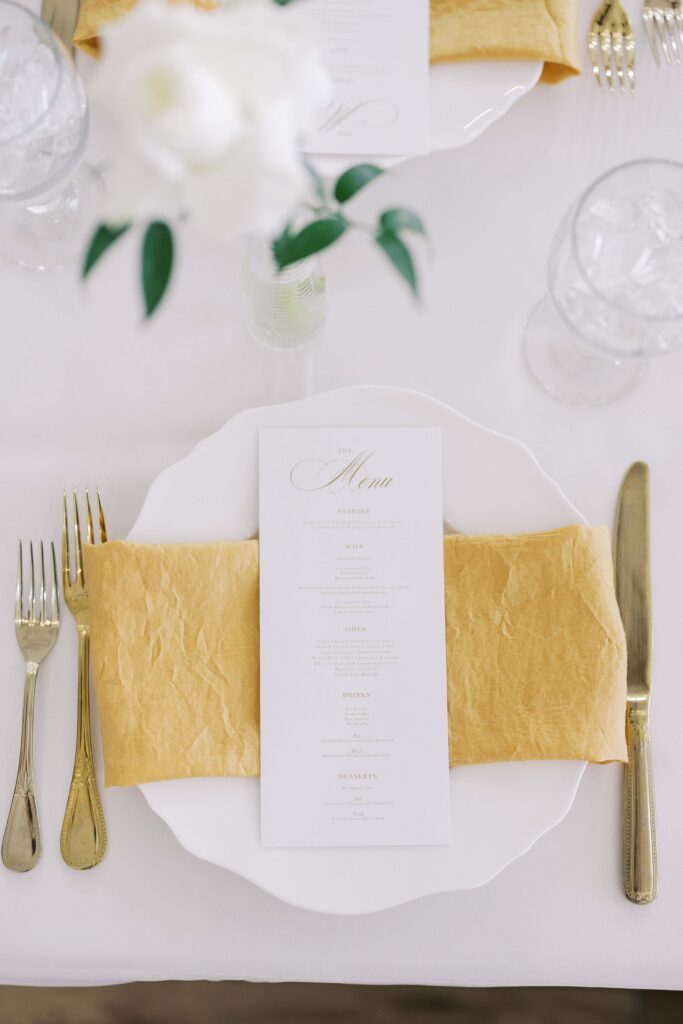 gold silverware and white plate at a Lakeview Hills Wedding