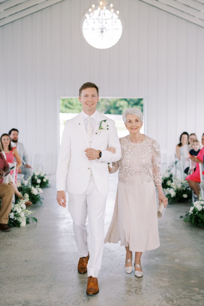 groom walking down the aisle with his grandma at his Lakeview Hills Wedding