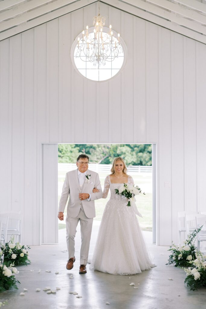 bride walking down the aisle with her dad at her Lakeview Hills Wedding