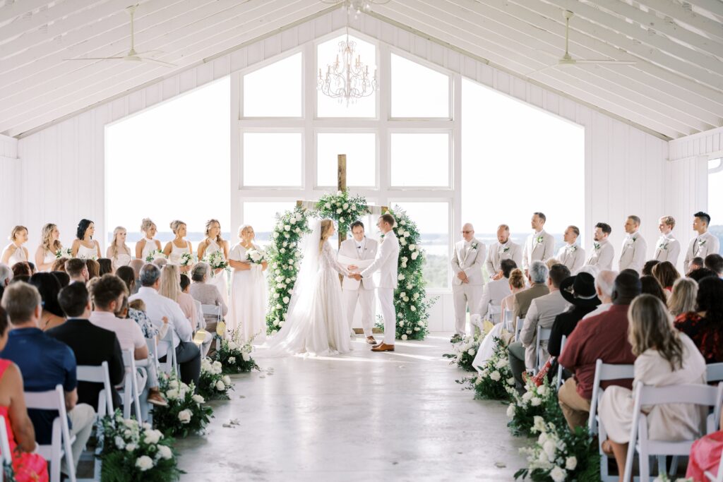 bride and groom holding hands at the altar during their Lakeview Hills Wedding