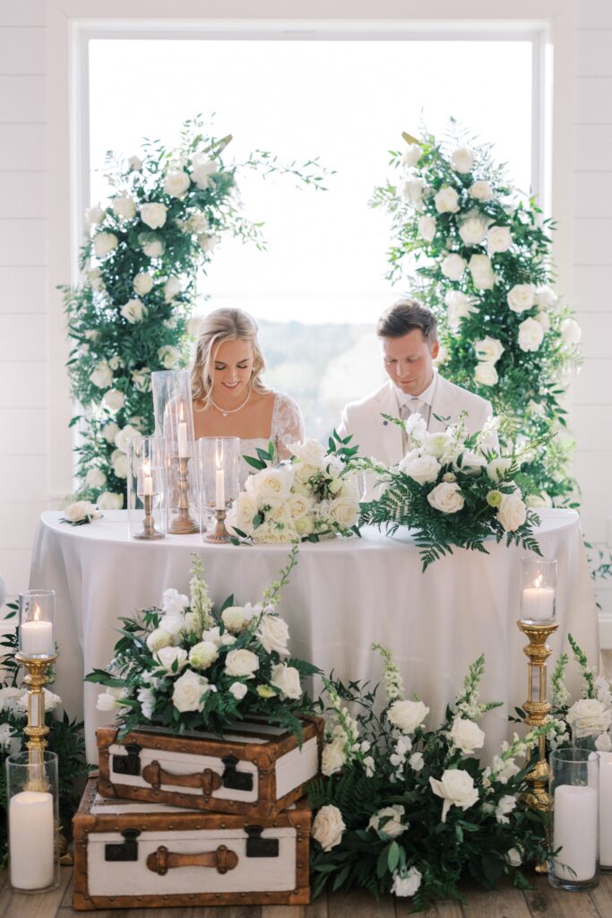 bride and groom at their table bowing their head during their Lakeview Hills Wedding