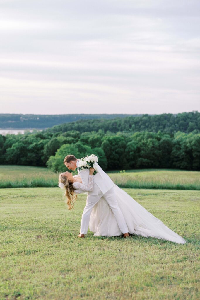 groom dipping his bride at their Lakeview Hills Wedding