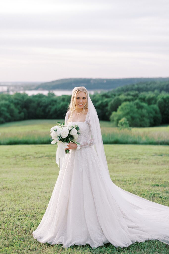bride in her dress with veil in her hair holding her white bouquqet at her Lakeview Hills Wedding
