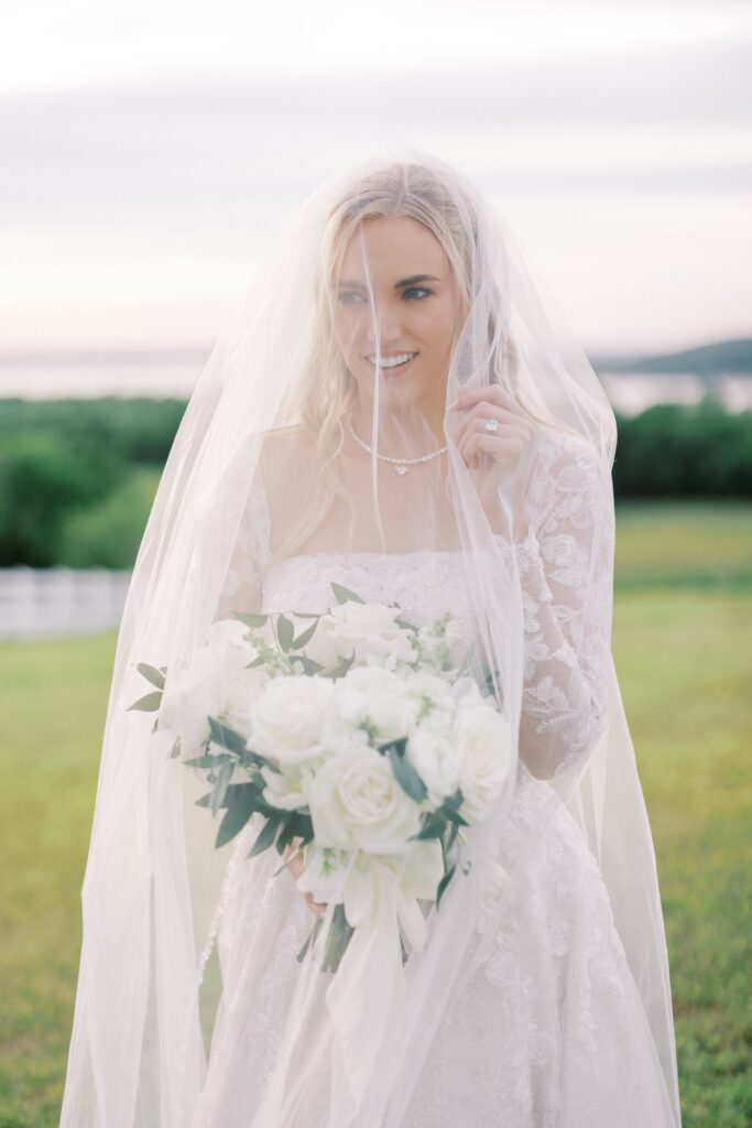 bride under her veil looking away at her Lakeview Hills Wedding