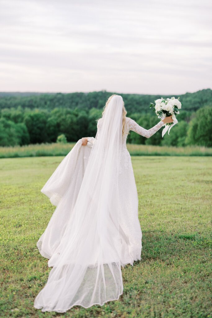 bride running away holding her dress up at her Lakeview Hills Wedding