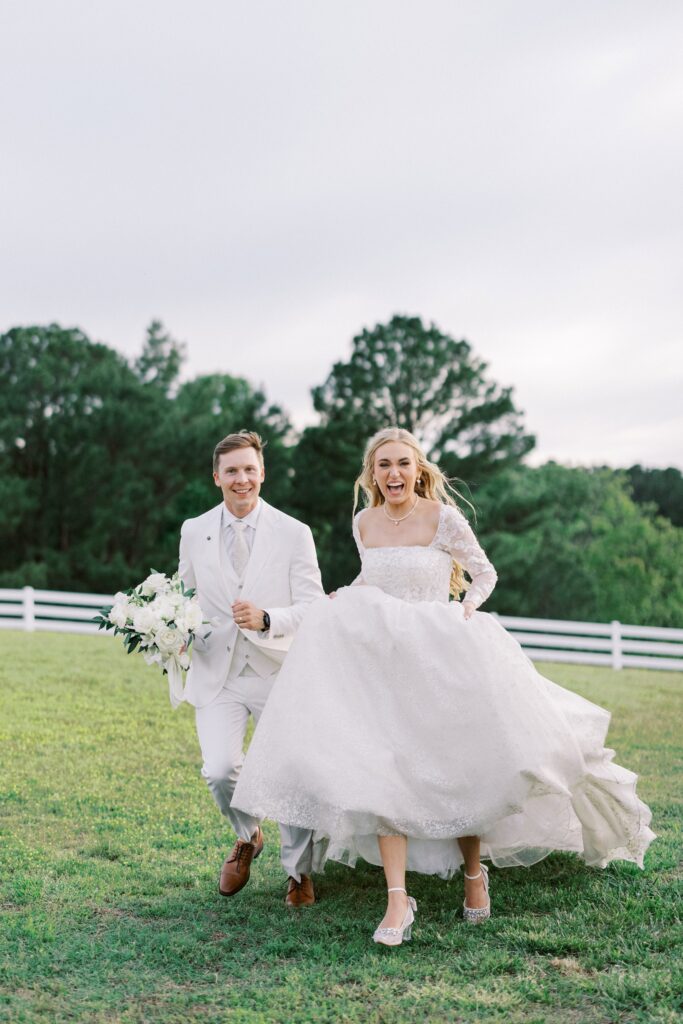 bride and groom running towards the camera at their Lakeview Hills Wedding