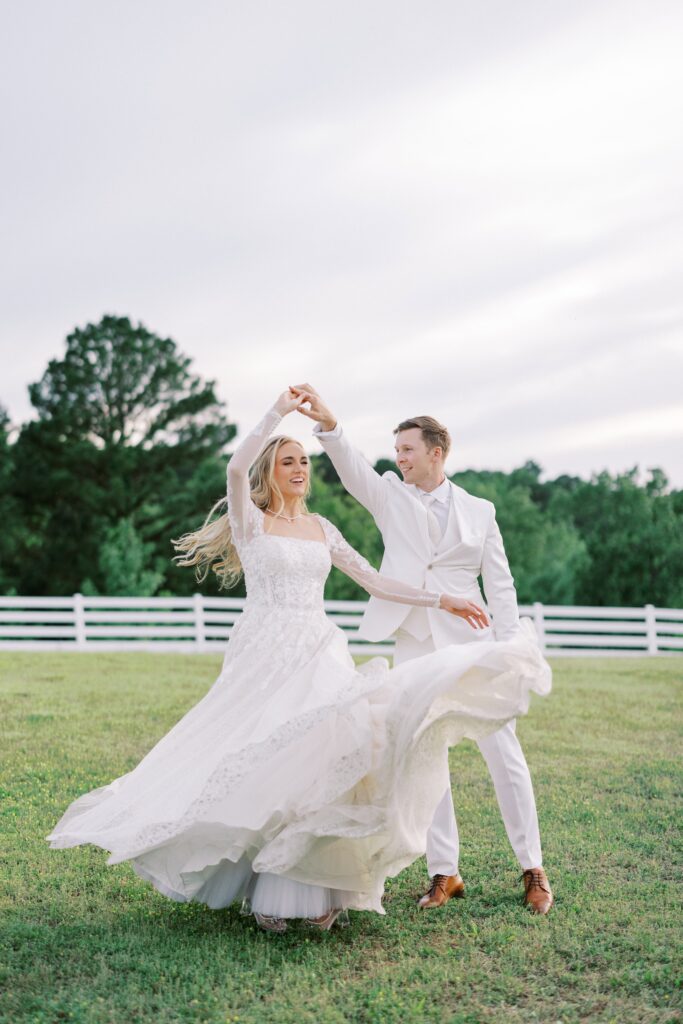 groom twirling his bride at their Lakeview Hills Wedding