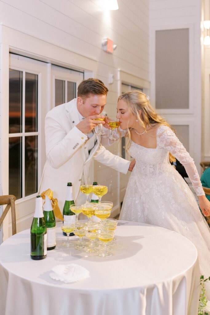 bride and groom drinking champagne at their Lakeview Hills Wedding
