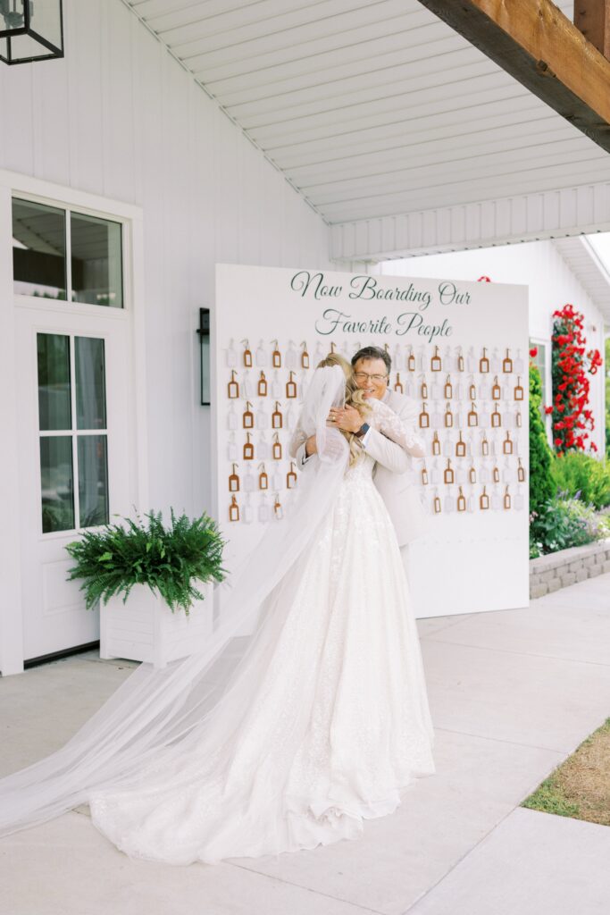 bride hugging her dad at this Lakeview Hills Wedding