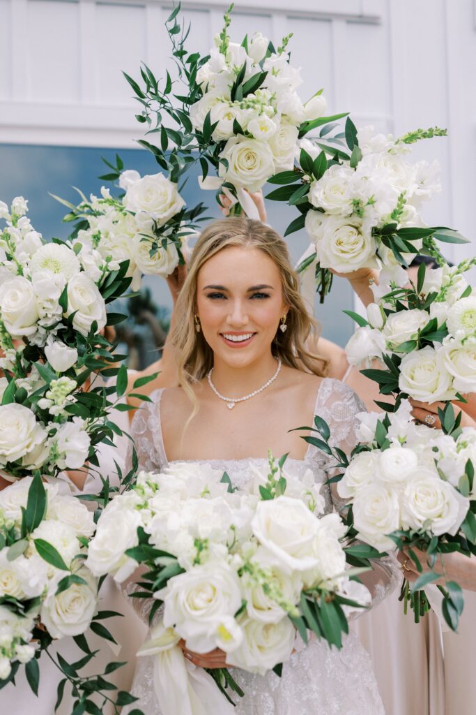 bridesmaids surrounding the bride with their bouquets at her Lakeview Hills Wedding