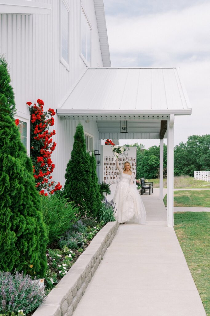 bride lifting her bouquet up to cheer at her Lakeview Hills Wedding