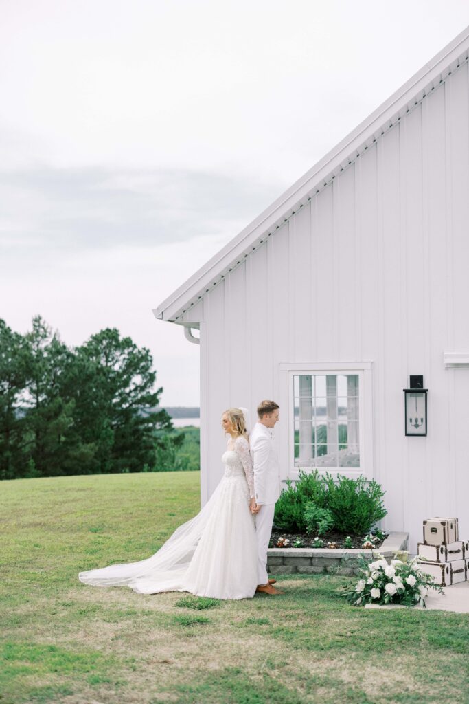 bride and groom back to back for their first touch at their Lakeview Hills Wedding