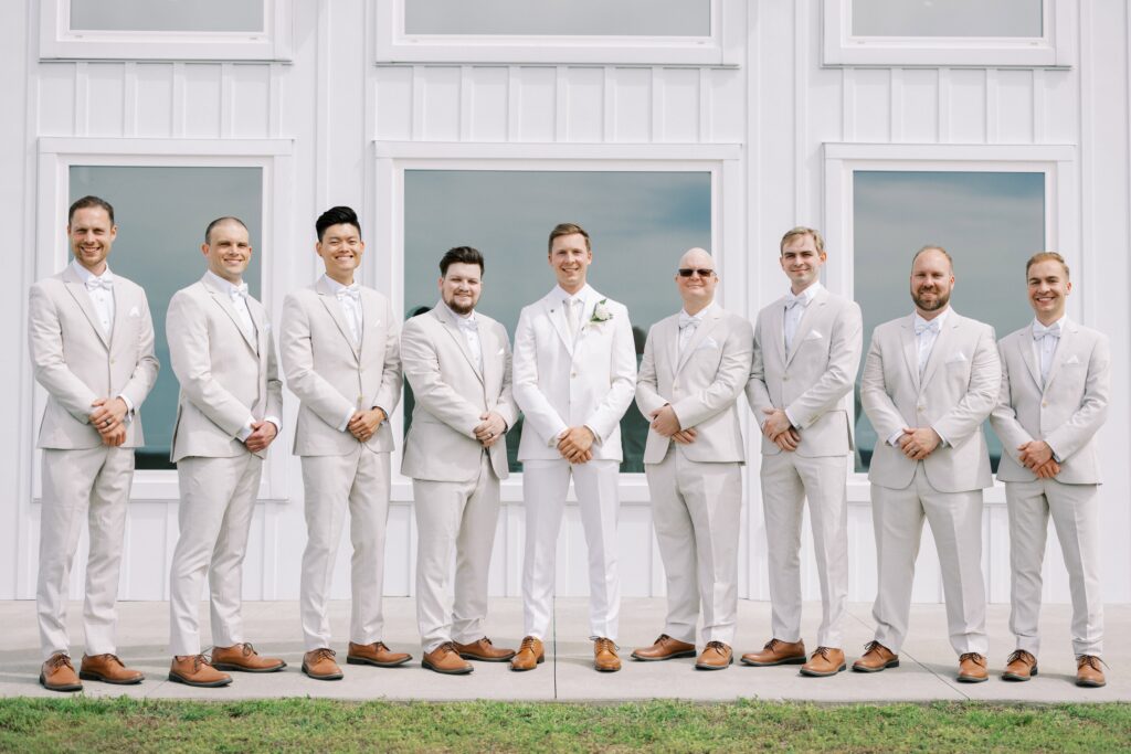 groom and his groomsmen all lined up at this Lakeview Hills Wedding