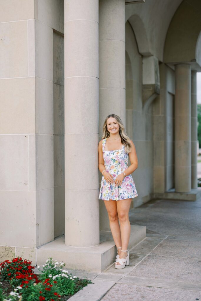 jodie leaning against the albritton bell tower at a senior portrait location