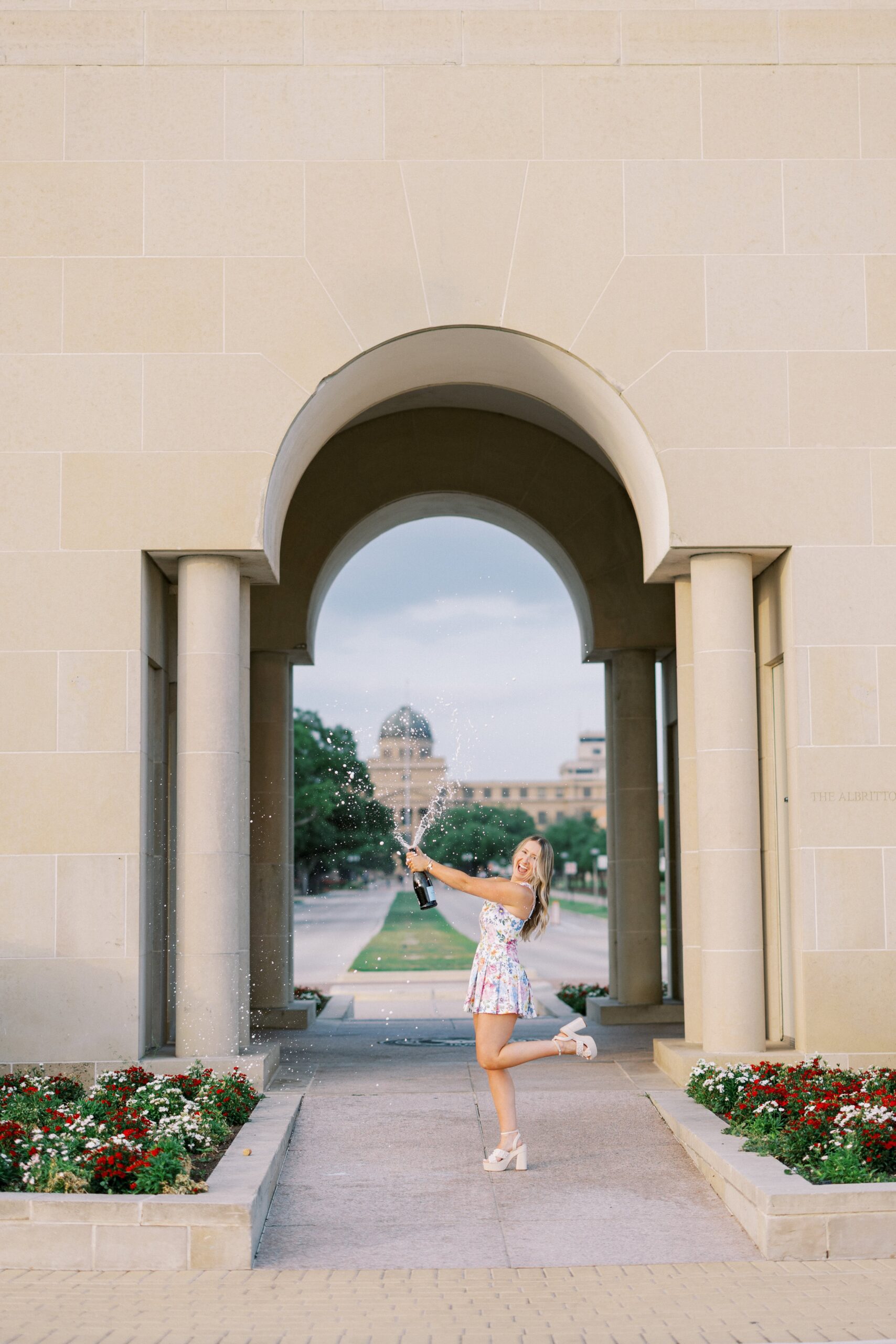 jodie poping champagne for graduation portraits ideas