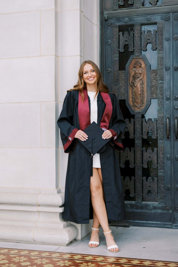 taylor holding her gown for graduation portraits ideas